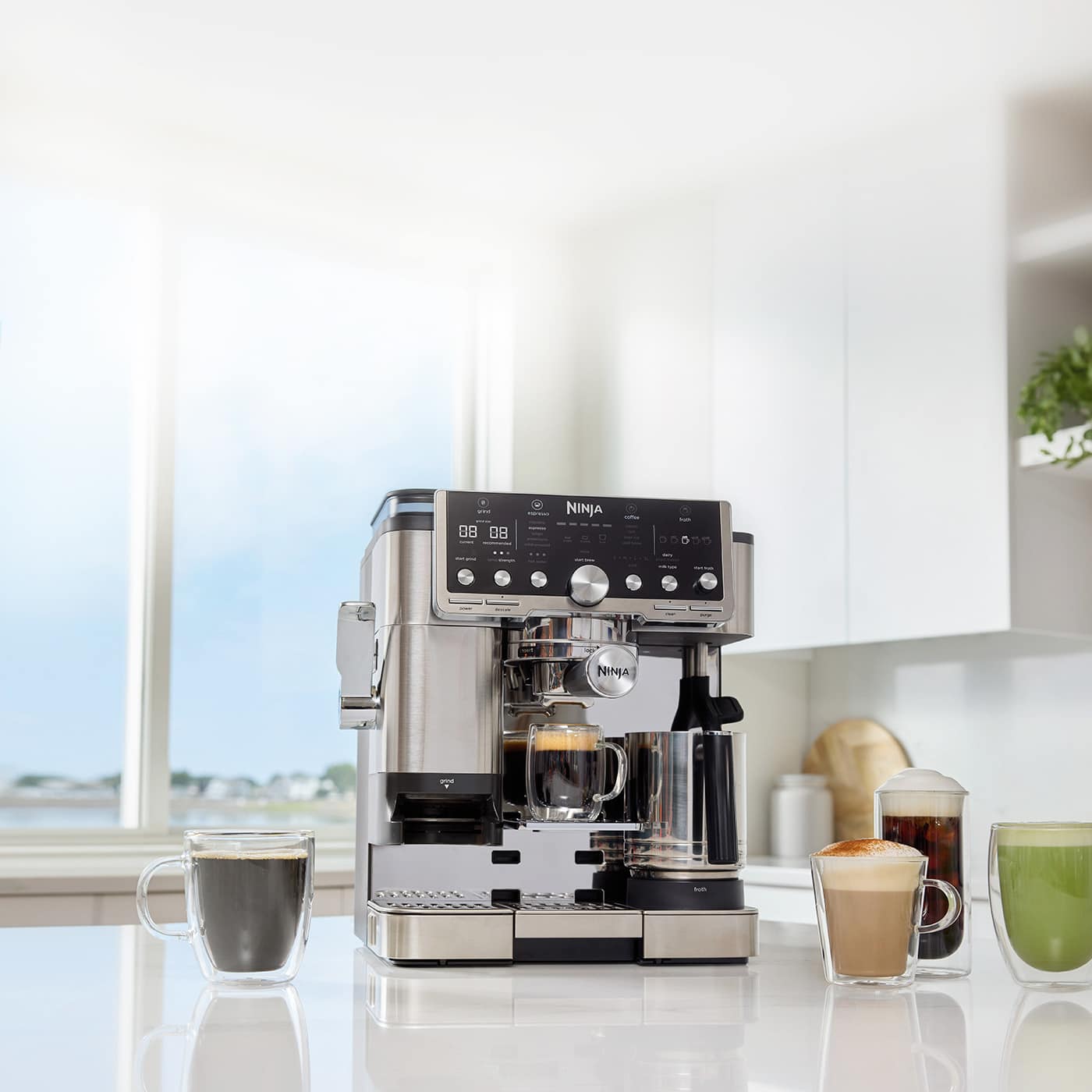 Ninja Luxe Café Pro Espresso Machine on a kitchen counter with coffee drinks.
